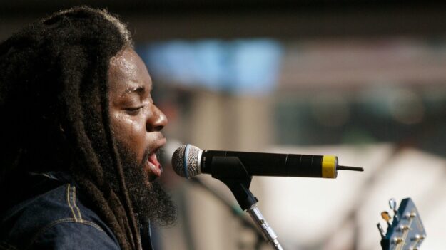 Peter Anthony Morgan of Morgan Heritage performs at the New Orleans zoo Jazz and Heritage festival Saturday, May 4, 2002, in New Orleans. (AP Photo/Douglas Mason, File)
